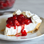 Cheesecake Recipe No Bake Cool Whip – Easy Creamy Dessert 5 Slice of cheesecake recipe no bake Cool Whip with cherry topping